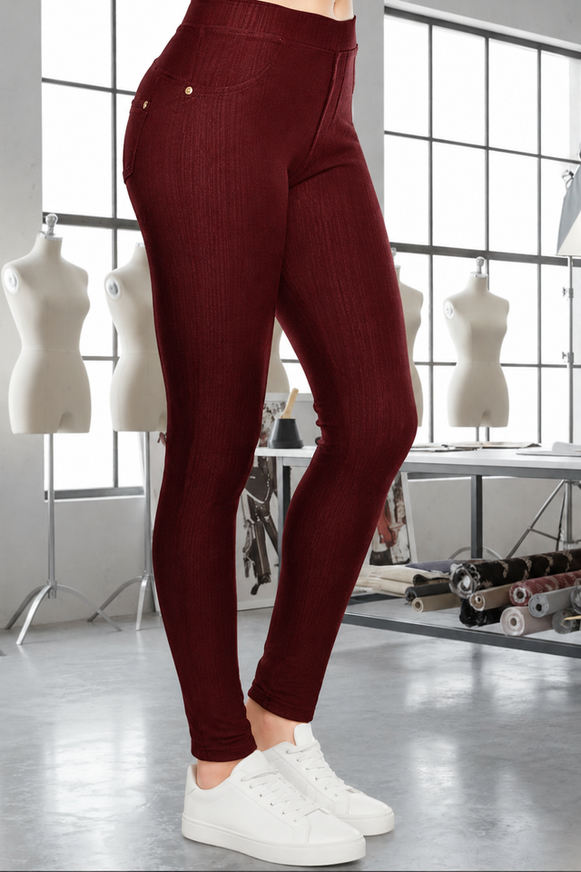 Magic Pant Crimson detail in the signature atelier setting, with white sneakers.
