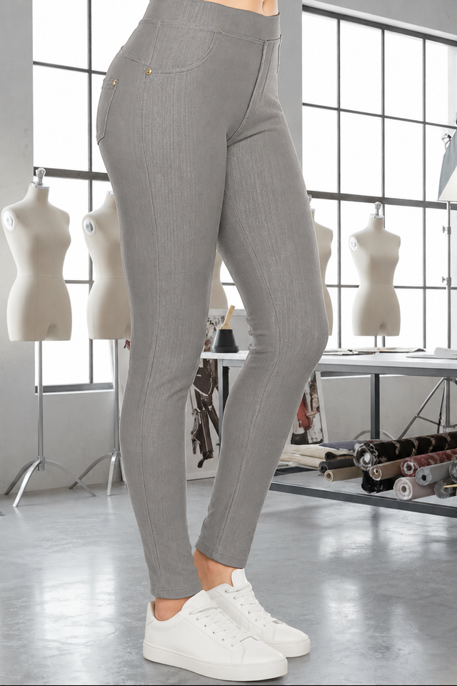 Magic Pant Light Grey detail in the signature atelier setting, with white sneakers.