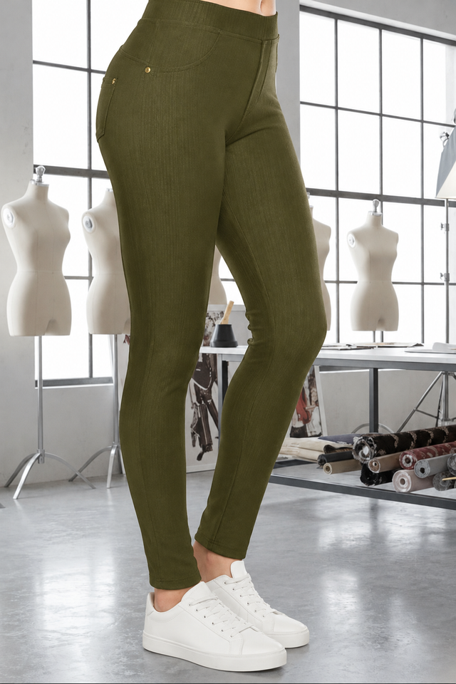 Magic Pant Olive detail in the signature atelier setting, with white sneakers.